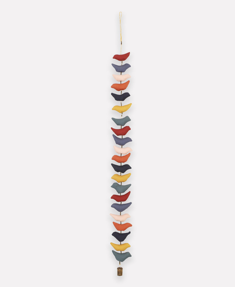 Colorful hanging mobile with various shapes on a white background
