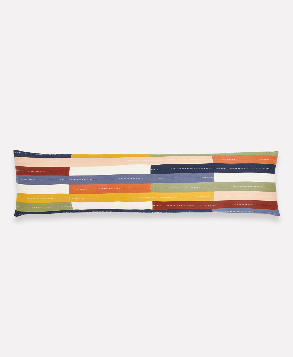 Long rectangular pillow with multicolored striped pattern on a white background