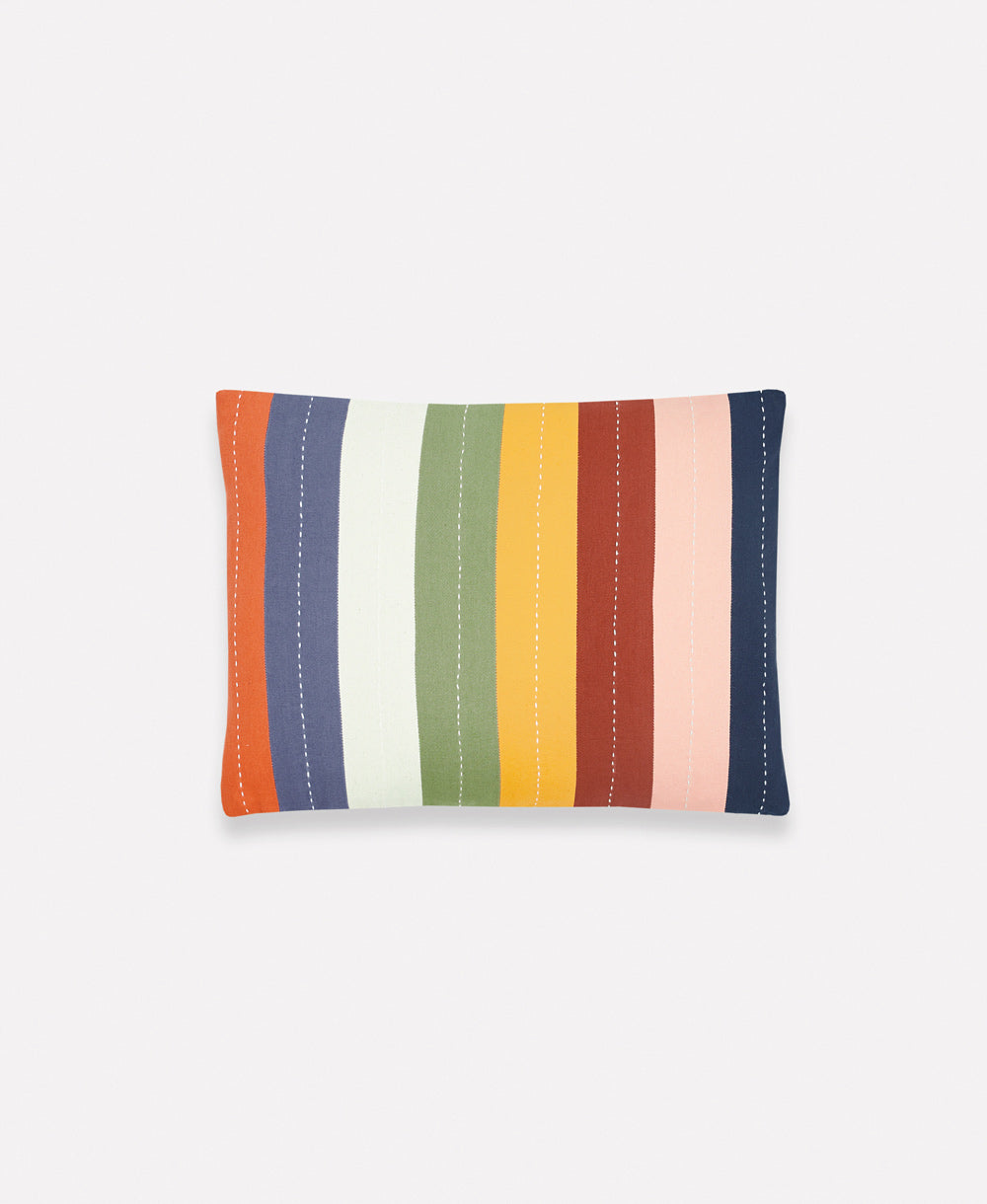 rainbow striped small pillow with white hand-stitched accents