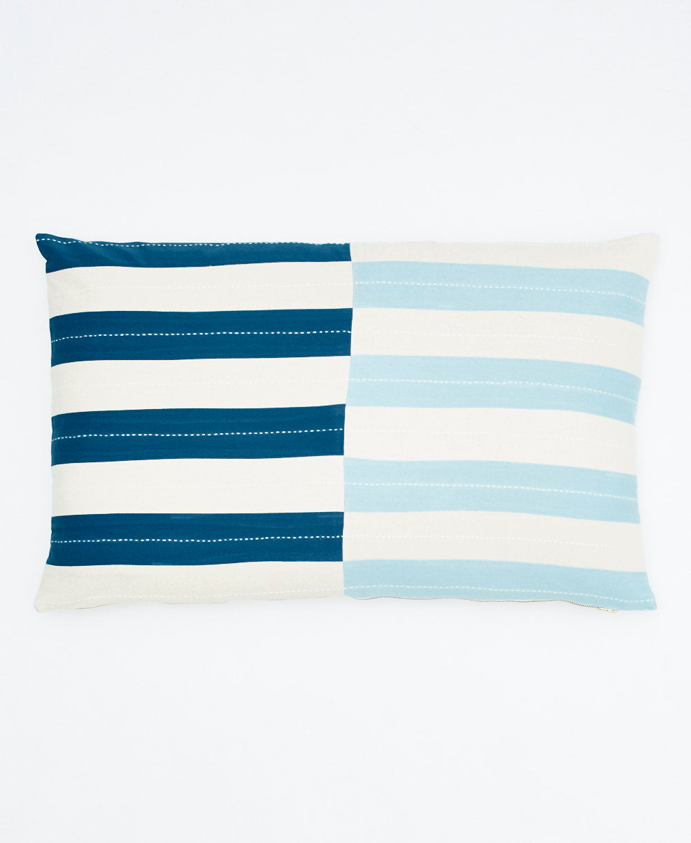 Striped pillow with blue and white horizontal stripes on a white background