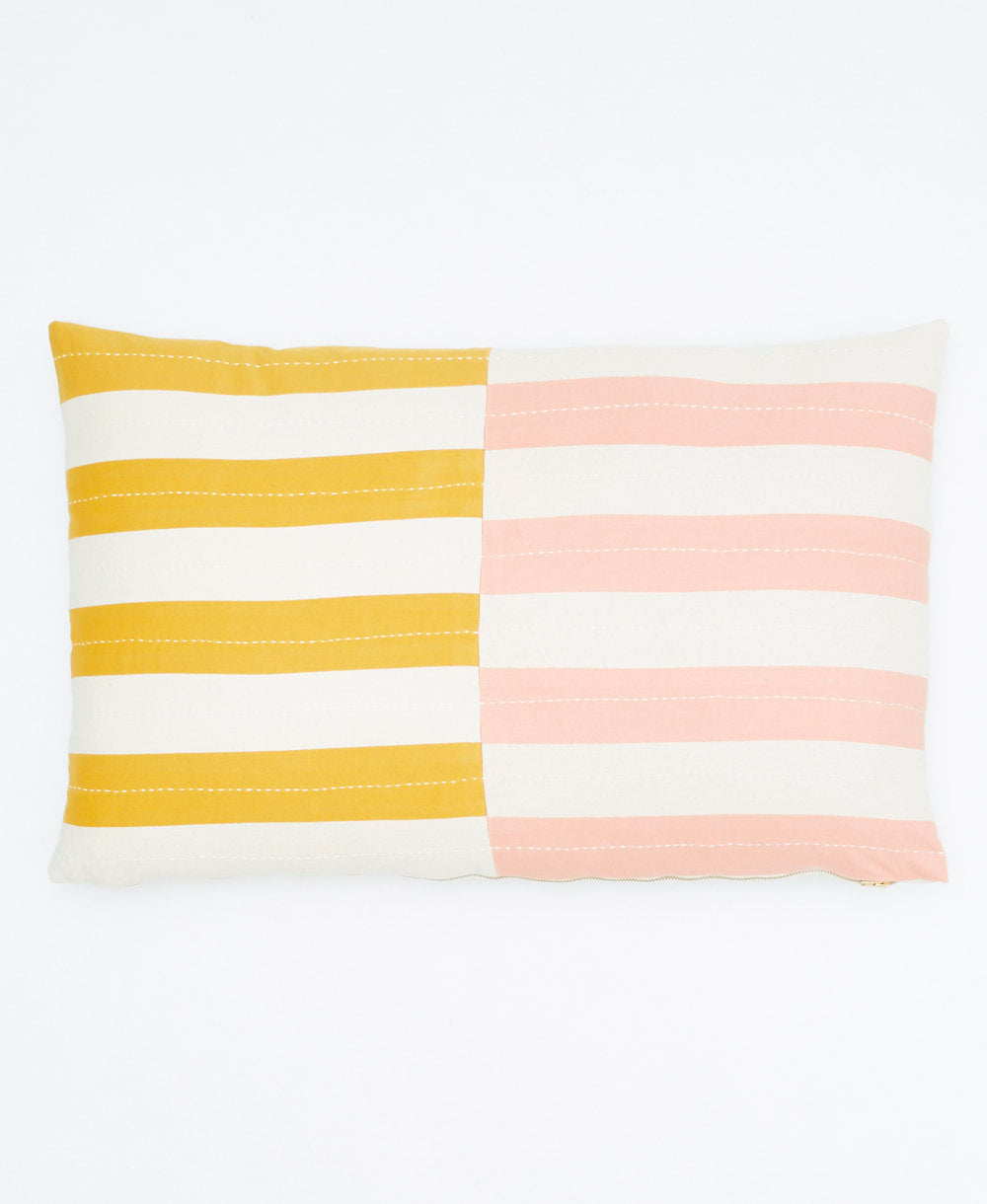 striped pillow with yellow, white, and pink horizontal stripes on a white background
