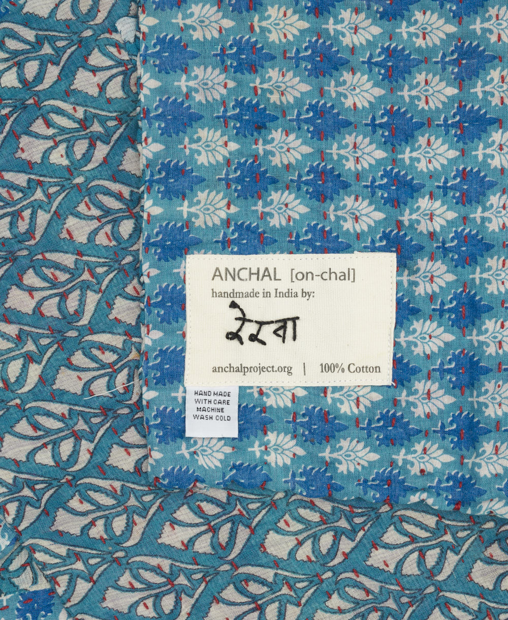 small kantha blanket with signature of the artisan maker on the tag