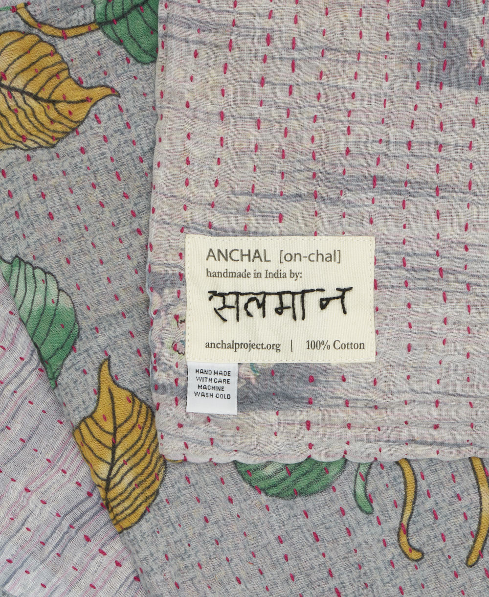 small kantha blanket with signature of the maker on the tag