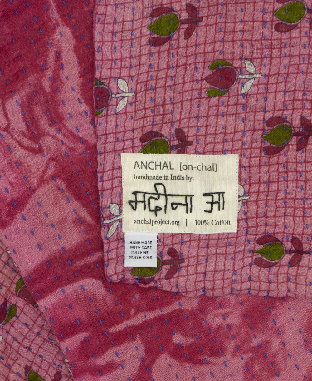 small kantha blanket with signature of the maker on the tag