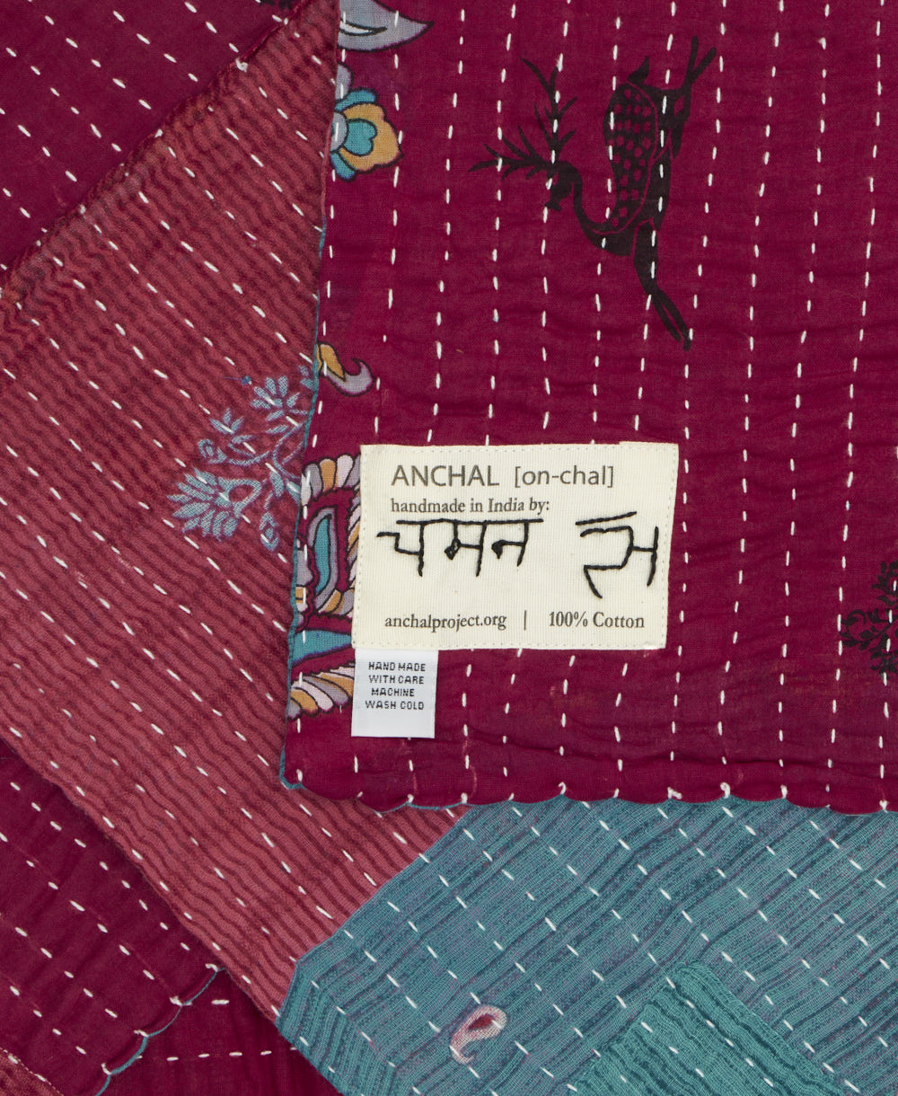 small kantha blanket with signature of the maker on the tag