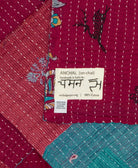 small kantha blanket with signature of the maker on the tag