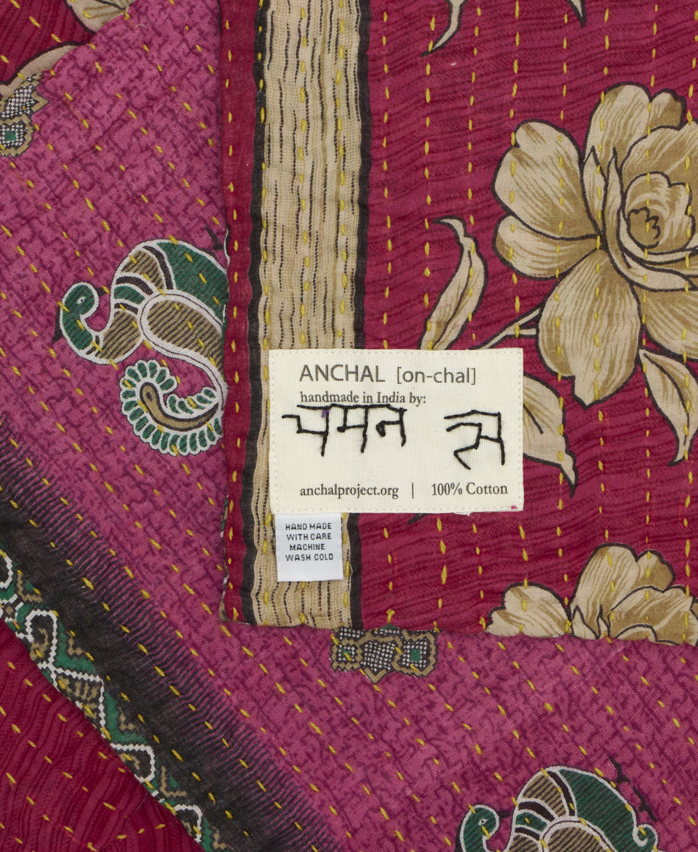 small kantha blanket with signature of the maker on the tag