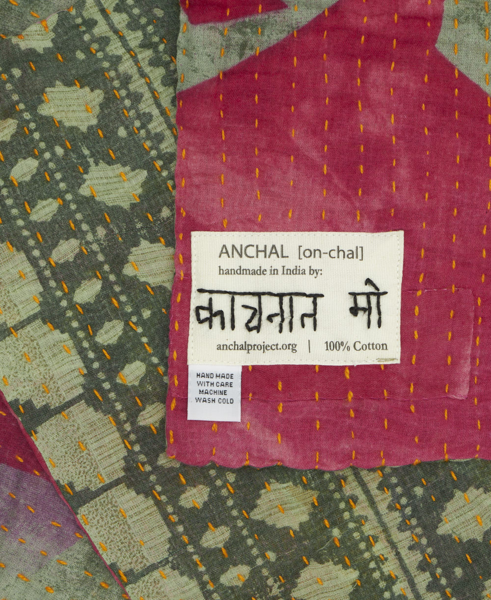 small kantha blanket with signature of the maker on the tag