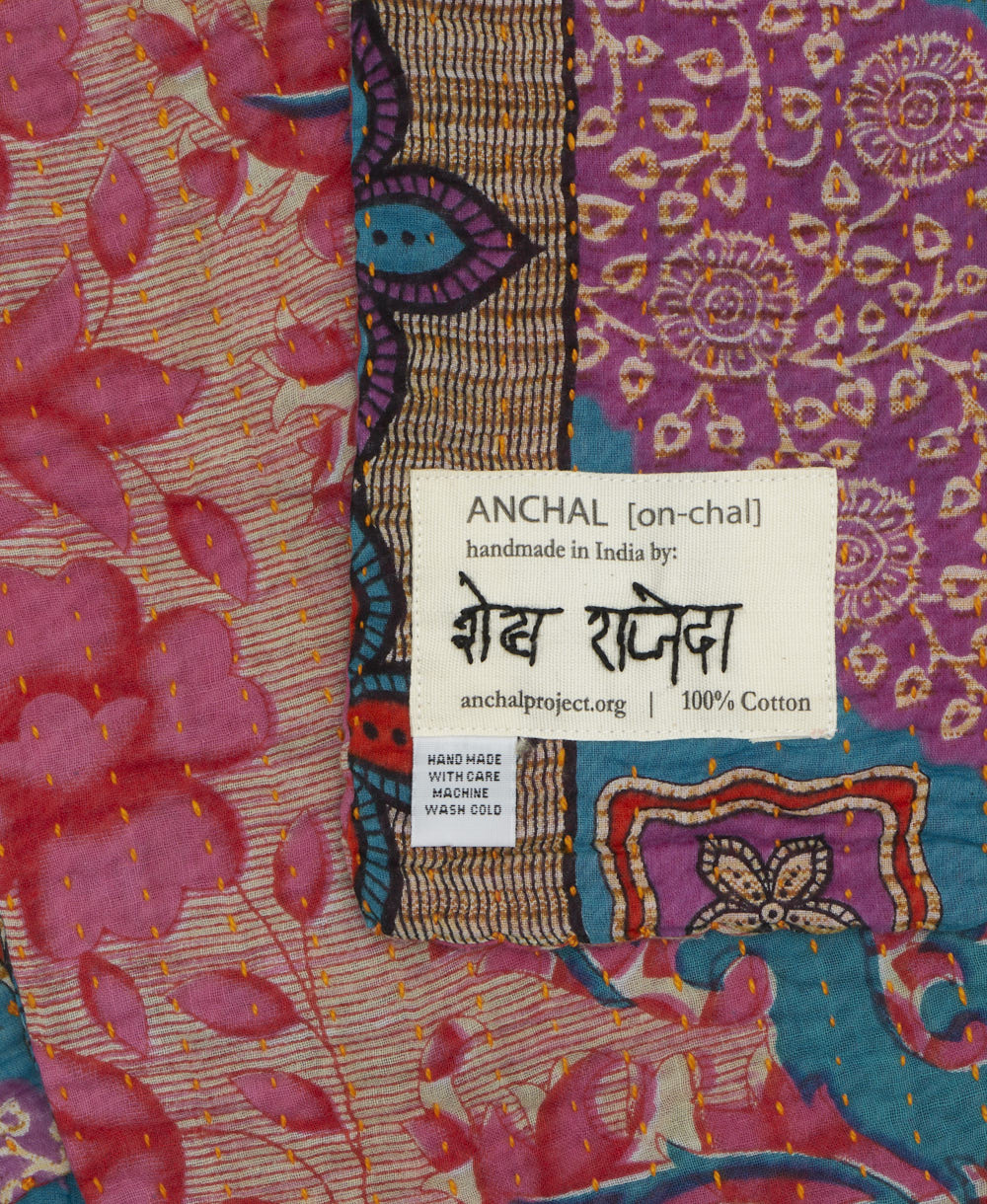 small kantha blanket with signature of the maker on the tag