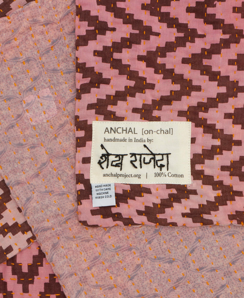 small kantha blanket with signature of the maker on the tag