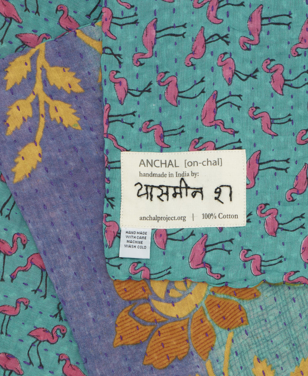 small kantha blanket with signature of the maker on the tag