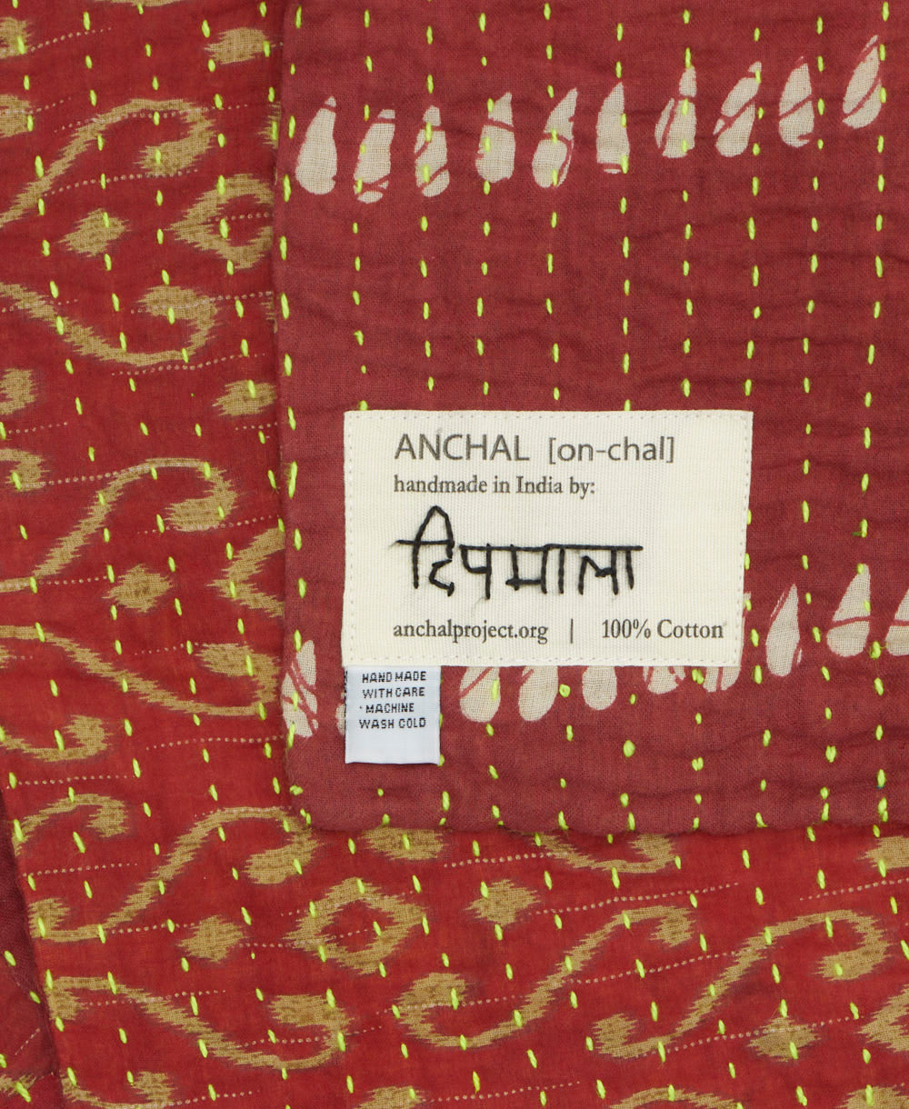 small kantha blanket with signature of the maker on the tag
