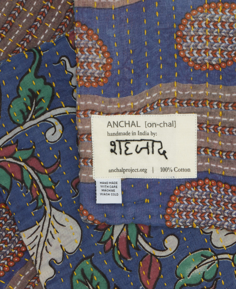 small kantha blanket with signature of the maker on the tag