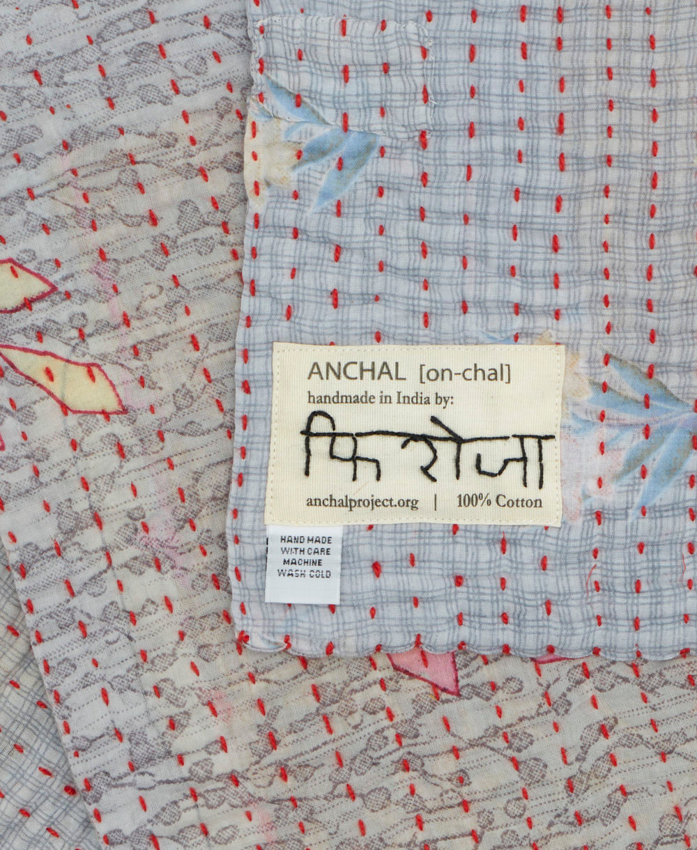 small kantha blanket with signature of the maker on the tag