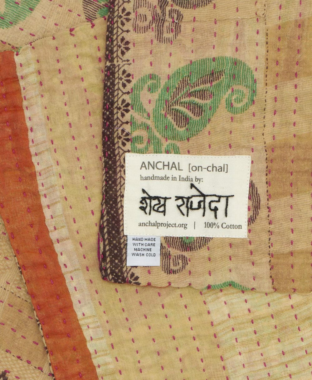 small kantha blanket with signature of the maker on the tag