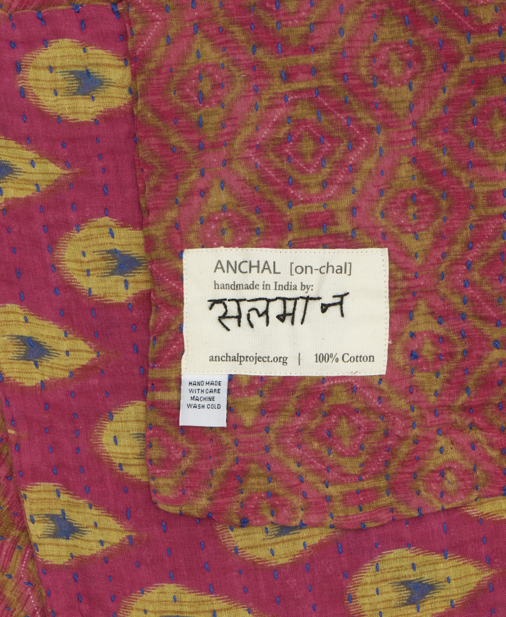 small kantha blanket with signature of the maker on the tag