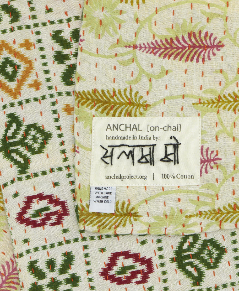 small kantha blanket with signature of the maker on the tag