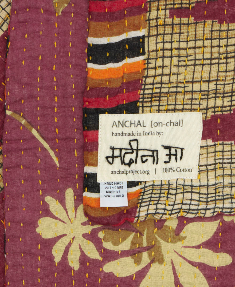 small kantha blanket with signature of the maker on the tag