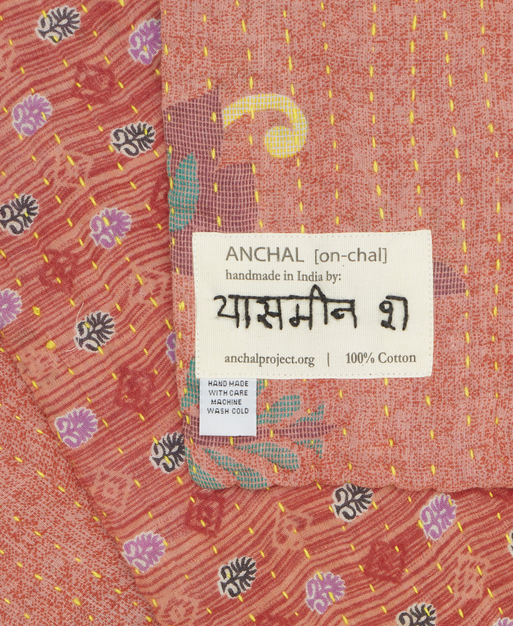 small kantha blanket with signature of the maker on the tag