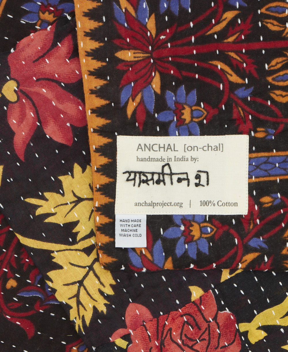 small kantha blanket with signature of the maker on the tag
