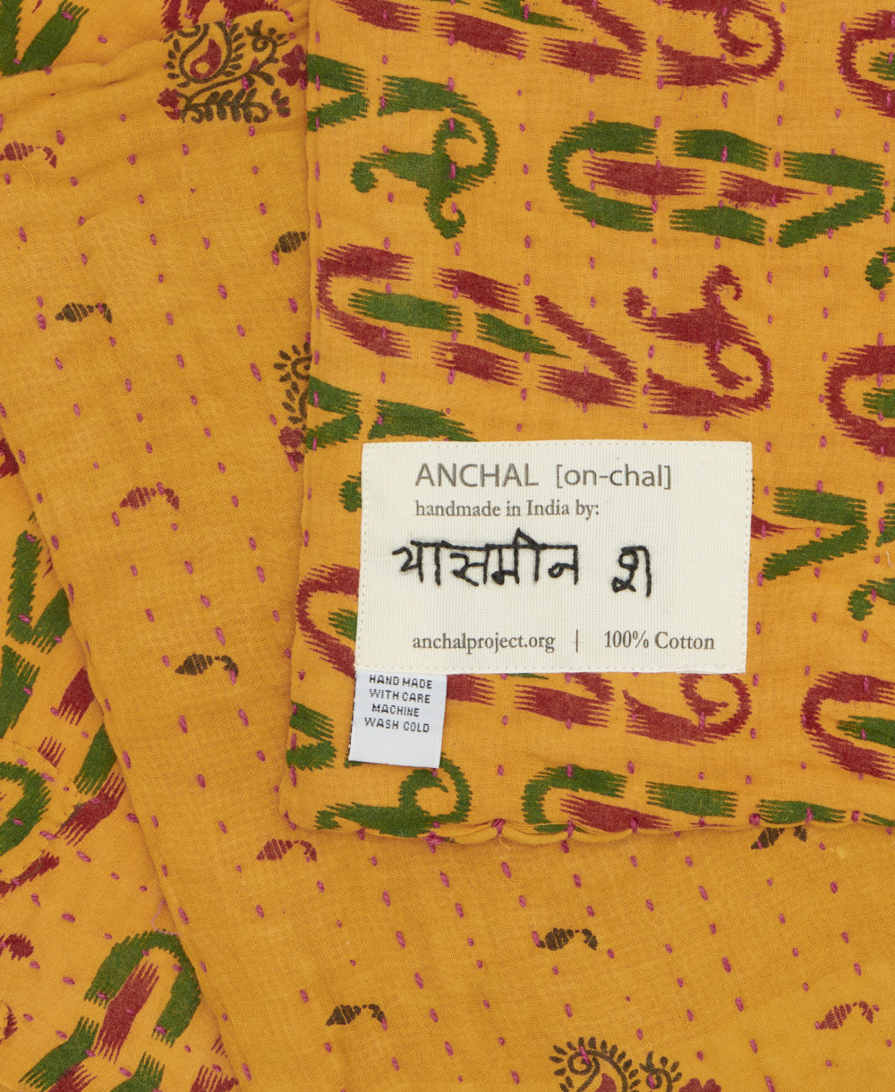 small kantha blanket with signature of the maker on the tag