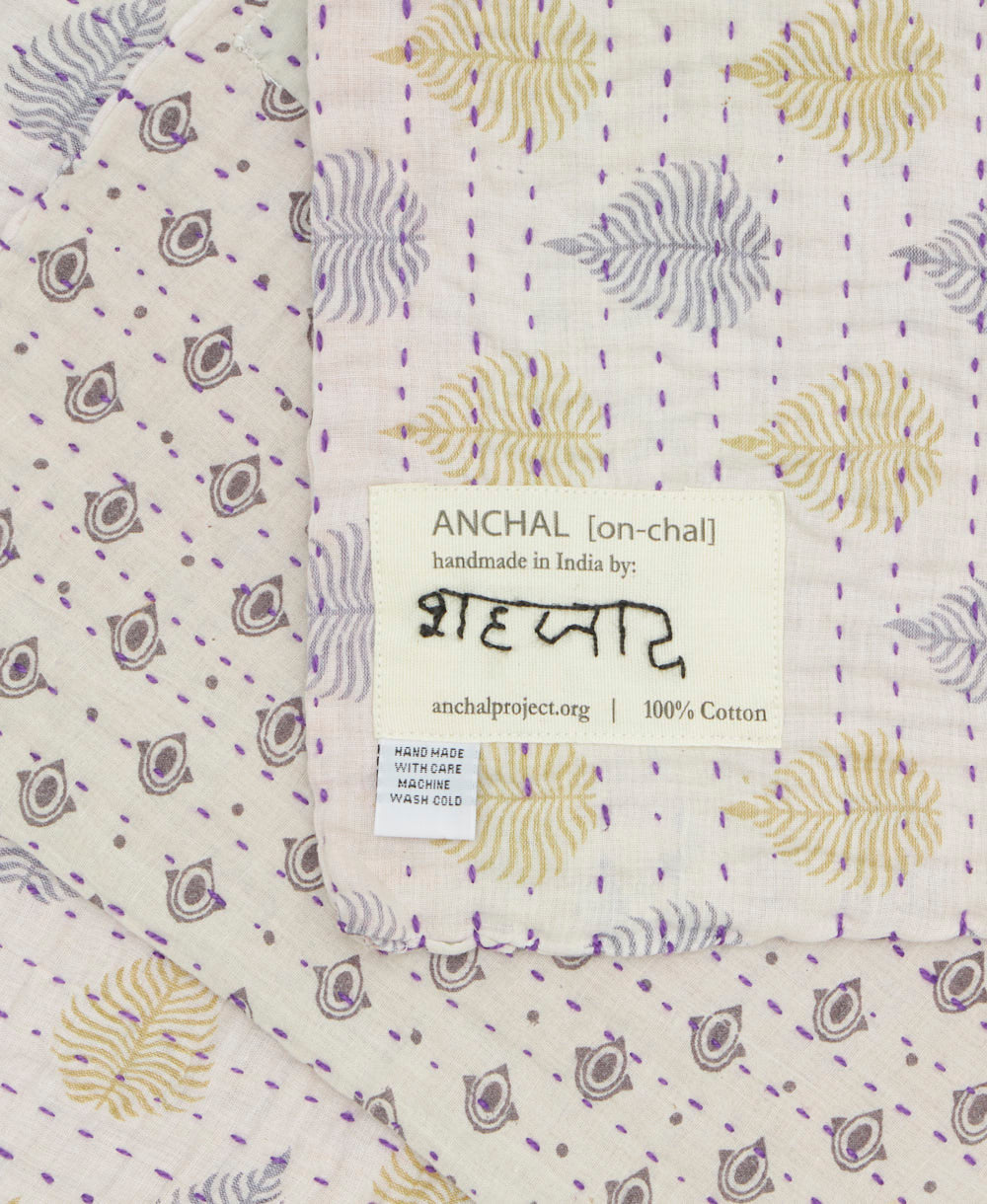 small kantha blanket with signature of the maker on the tag