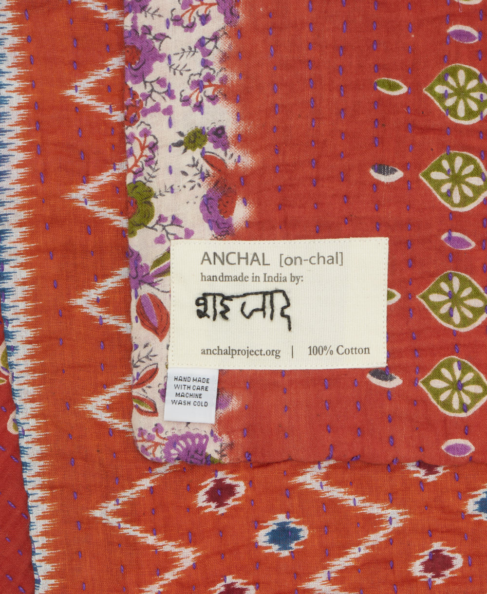 small kantha blanket with signature of the maker on the tag