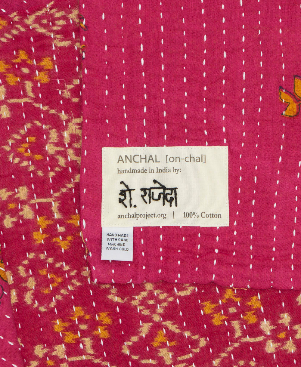 small kantha blanket with signature of the maker on the tag