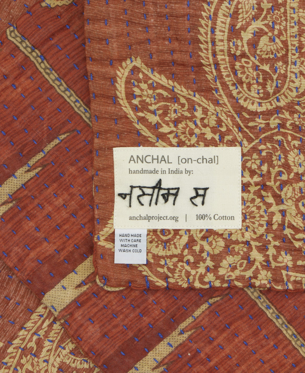 small kantha blanket with signature of the maker on the tag