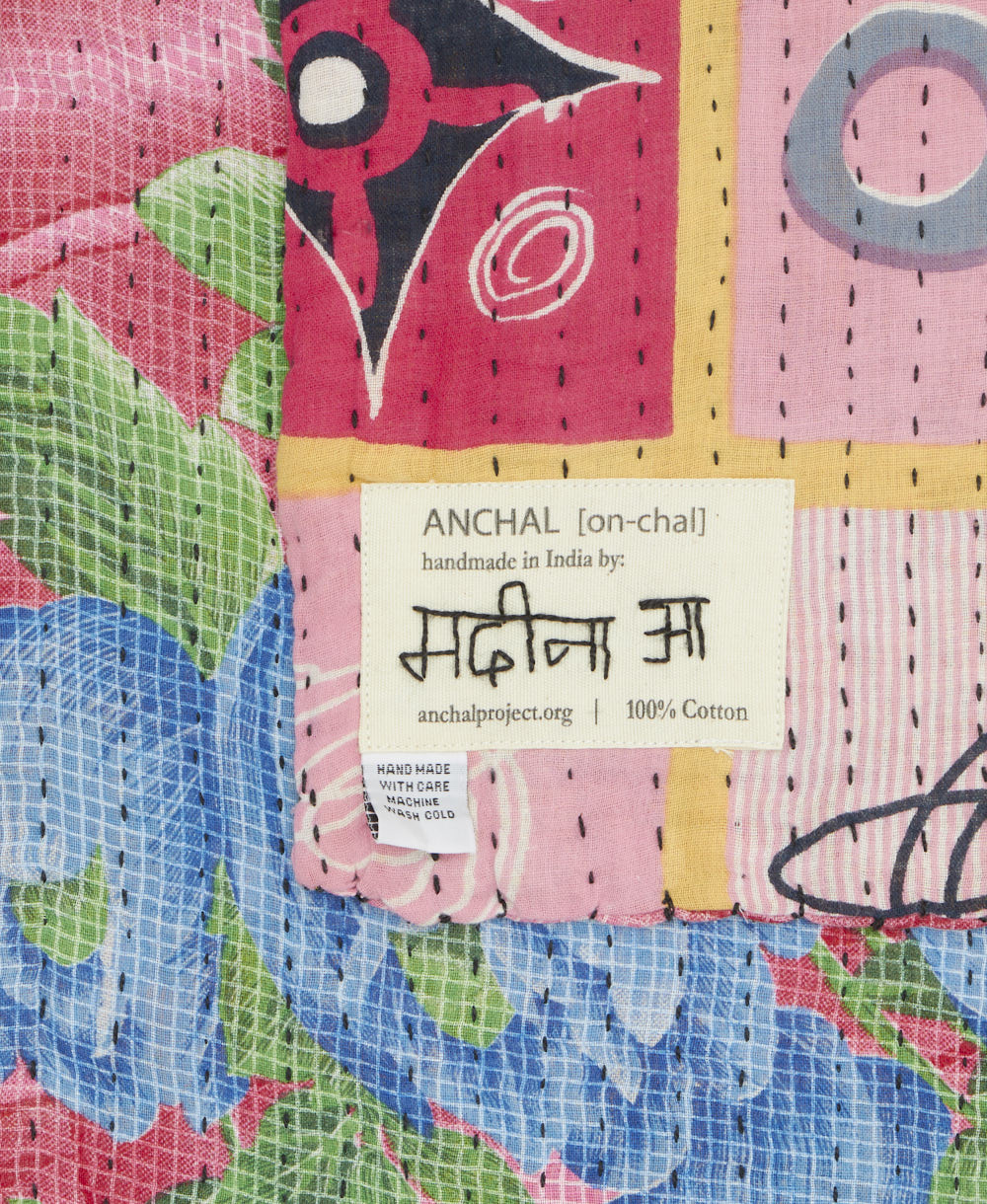 small kantha blanket with signature of the maker on the tag