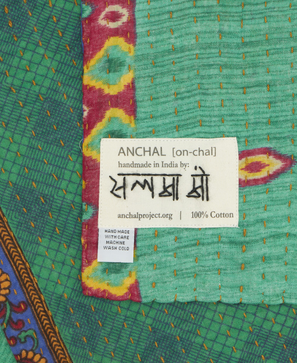 small kantha blanket with signature of the maker on the tag