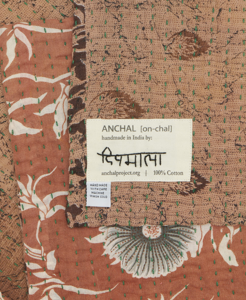 small kantha blanket with signature of the maker on the tag