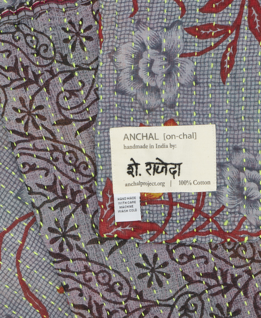 small kantha blanket with signature of the maker on the tag