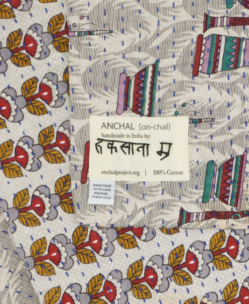 small kantha blanket with signature of the maker on the tag