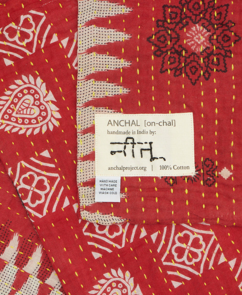 small kantha blanket with signature of the maker on the tag