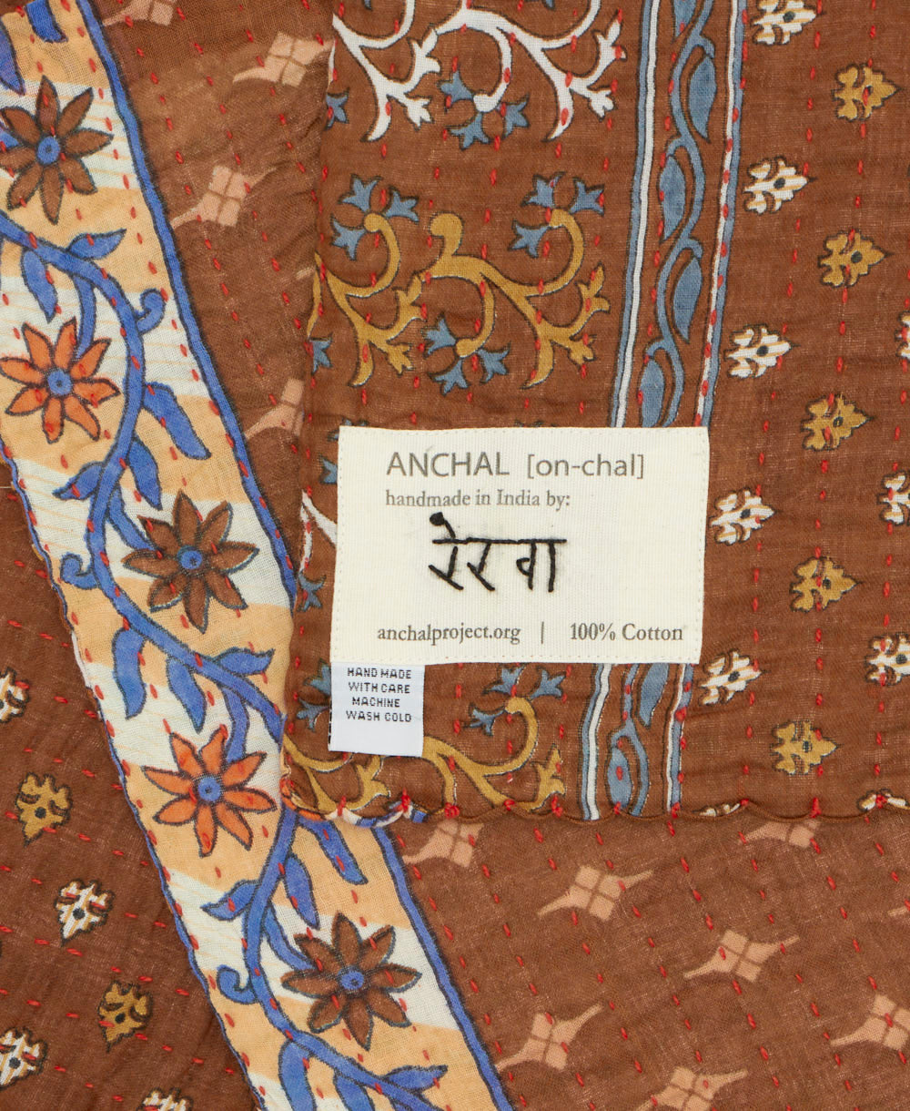 small kantha blanket with signature of the maker on the tag
