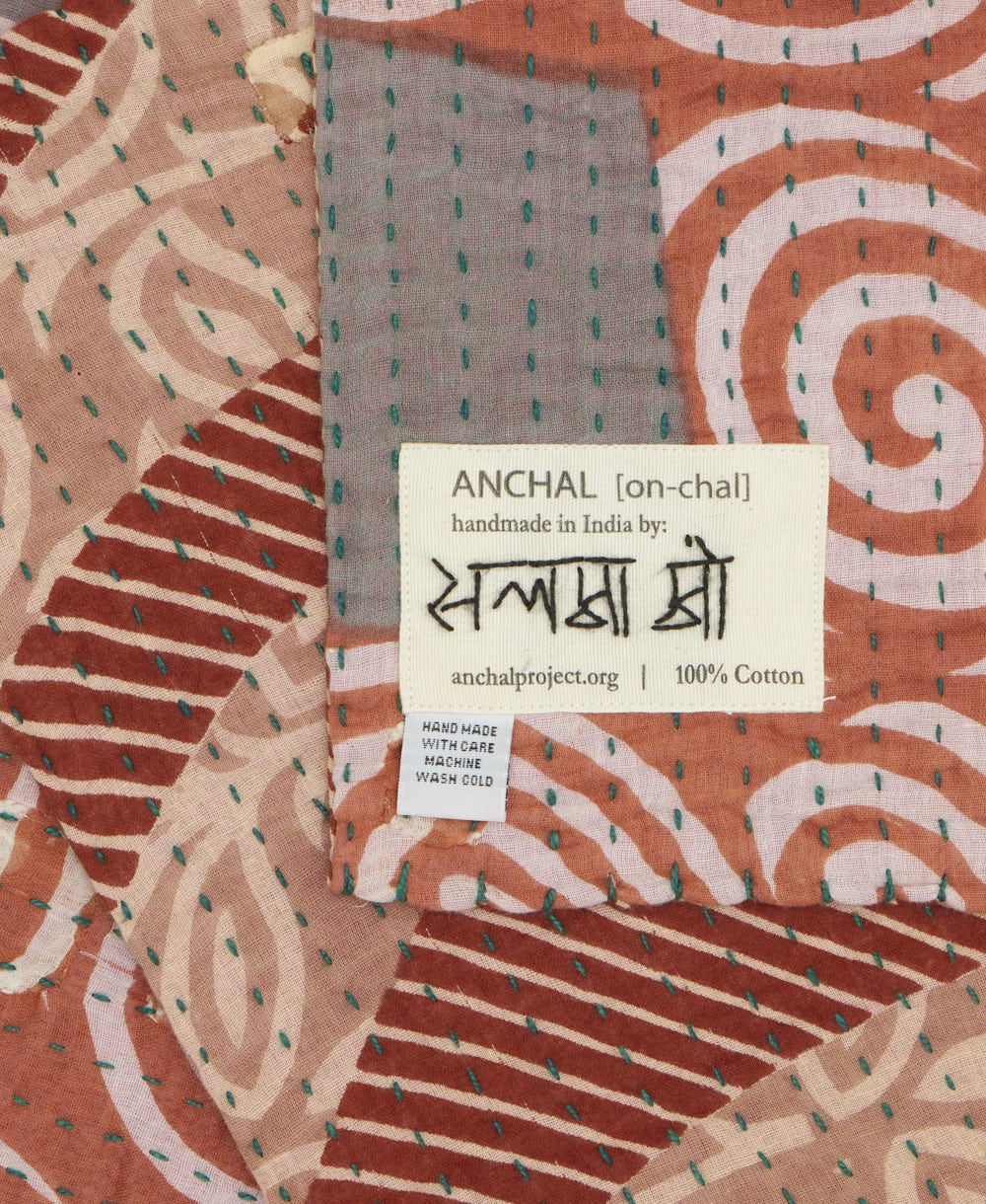 small kantha blanket with signature of the maker on the tag