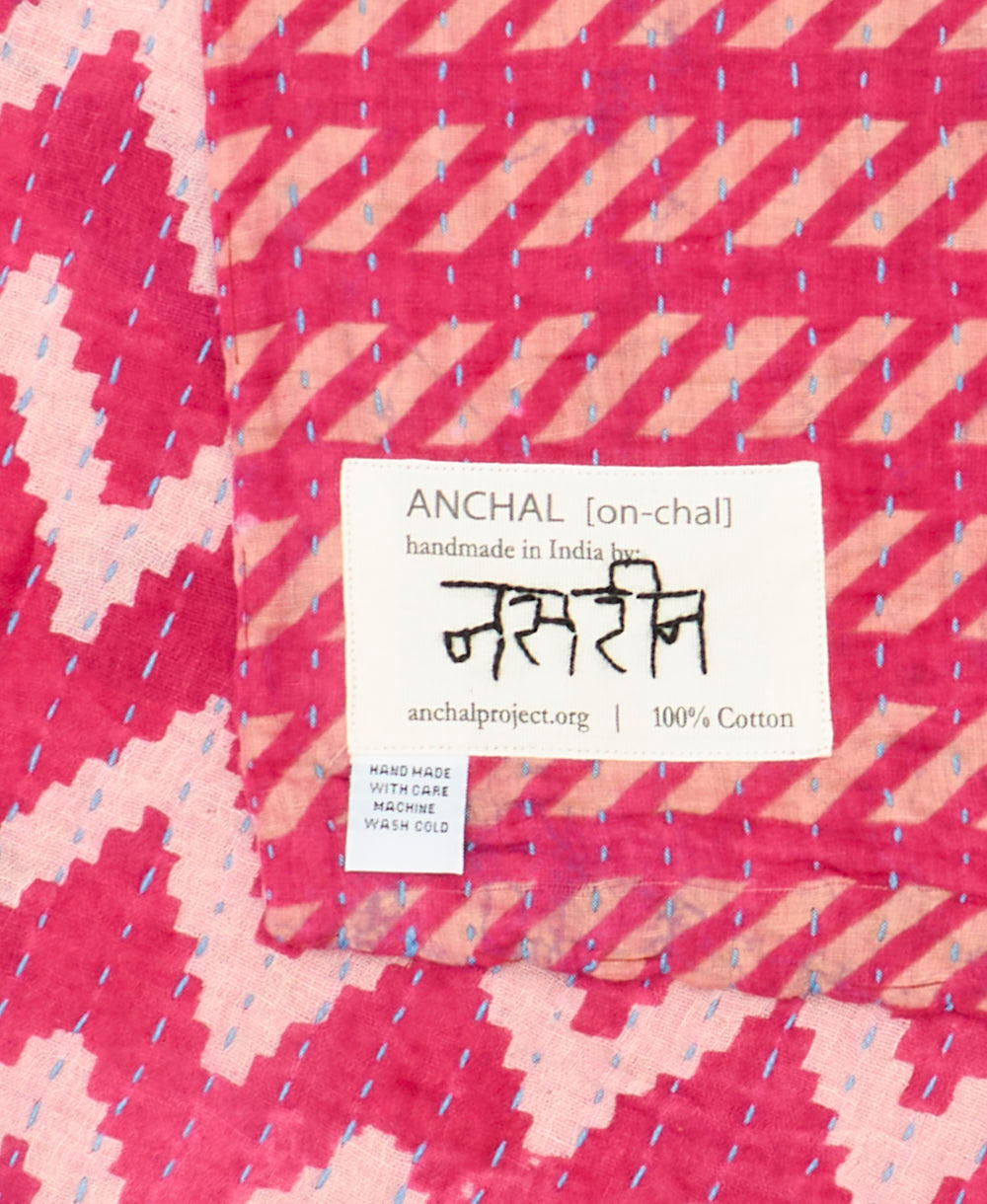 small kantha blanket with signature of the maker on the tag