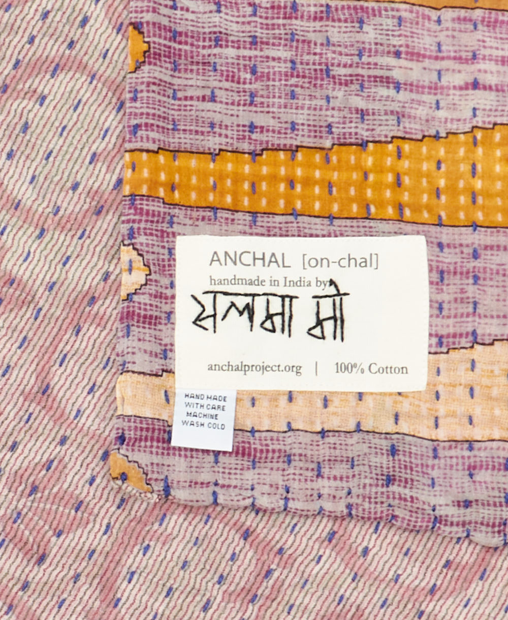 small kantha blanket with signature of the maker on the tag