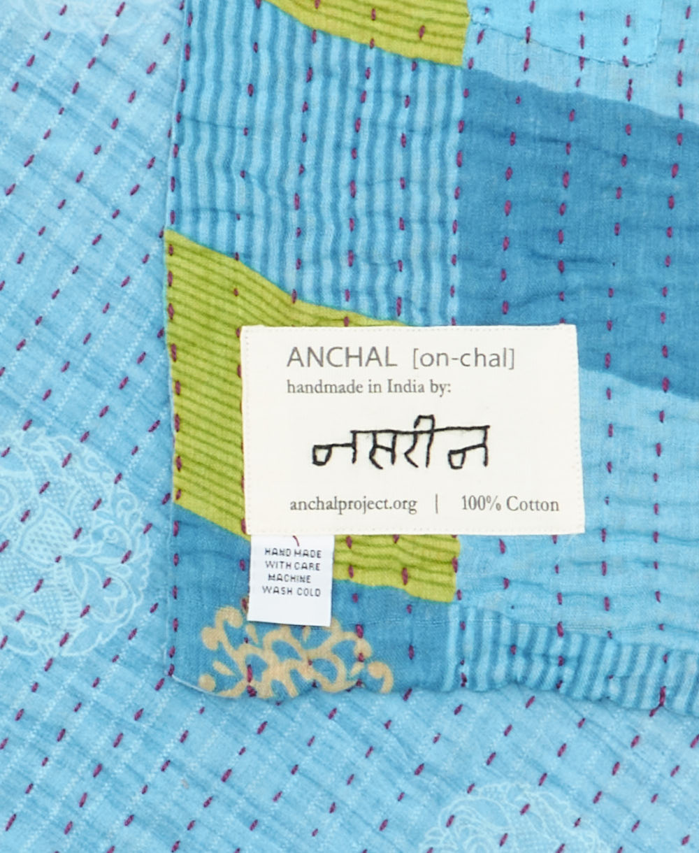 small kantha blanket with signature of the maker on the tag