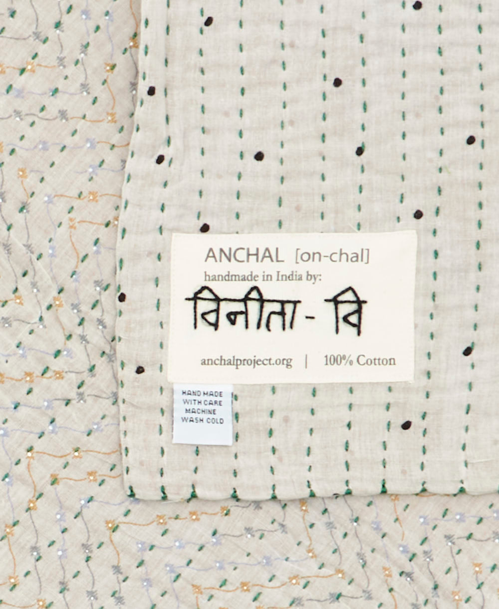 small kantha blanket with signature of the maker on the tag
