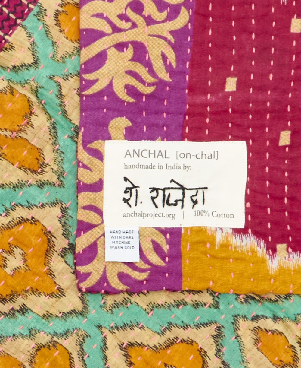 small kantha blanket with signature of the maker on the tag