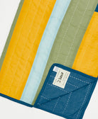 Colorful quilt with a label on a white background