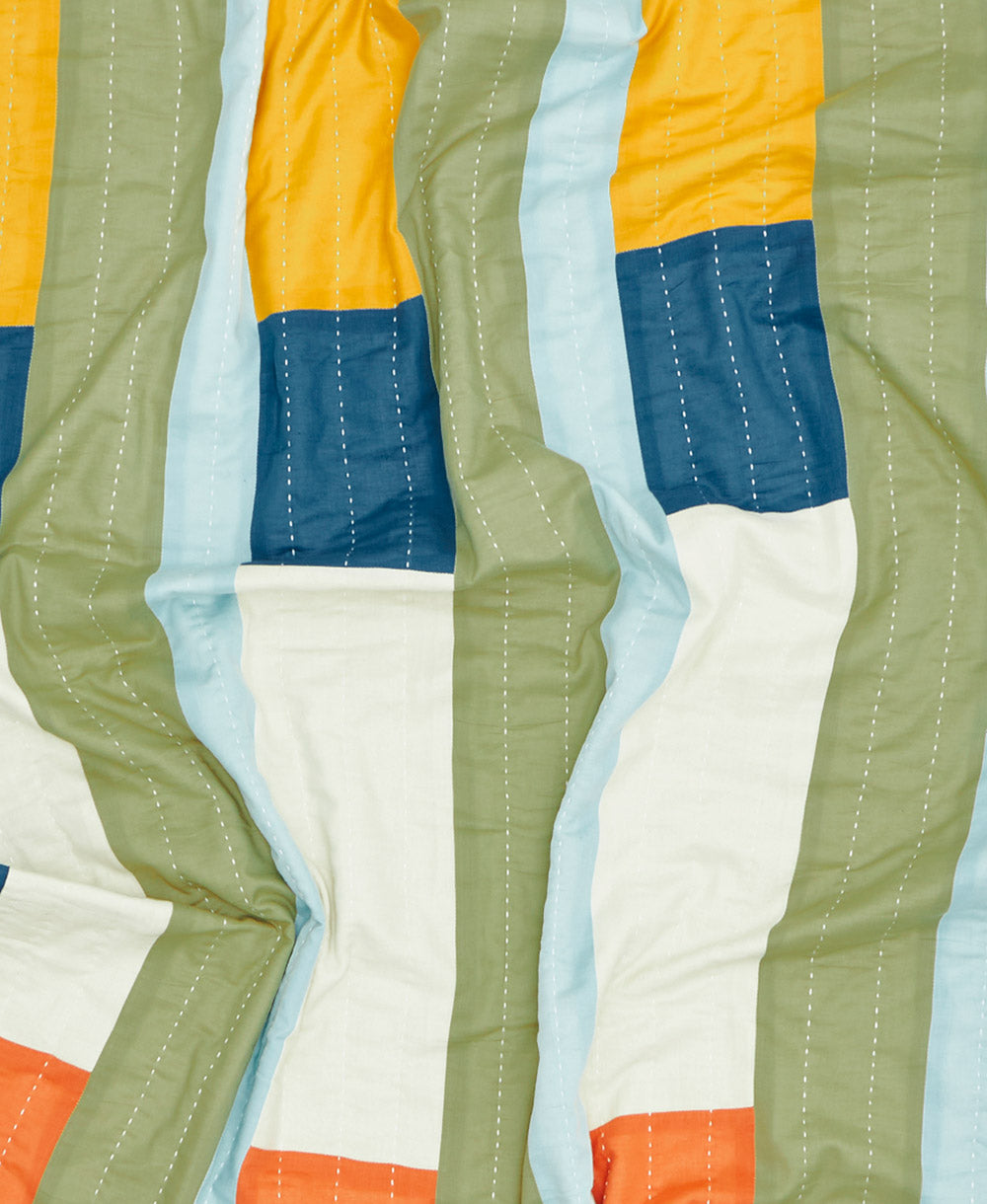 Colorful quilt with geometric pattern on a blue background