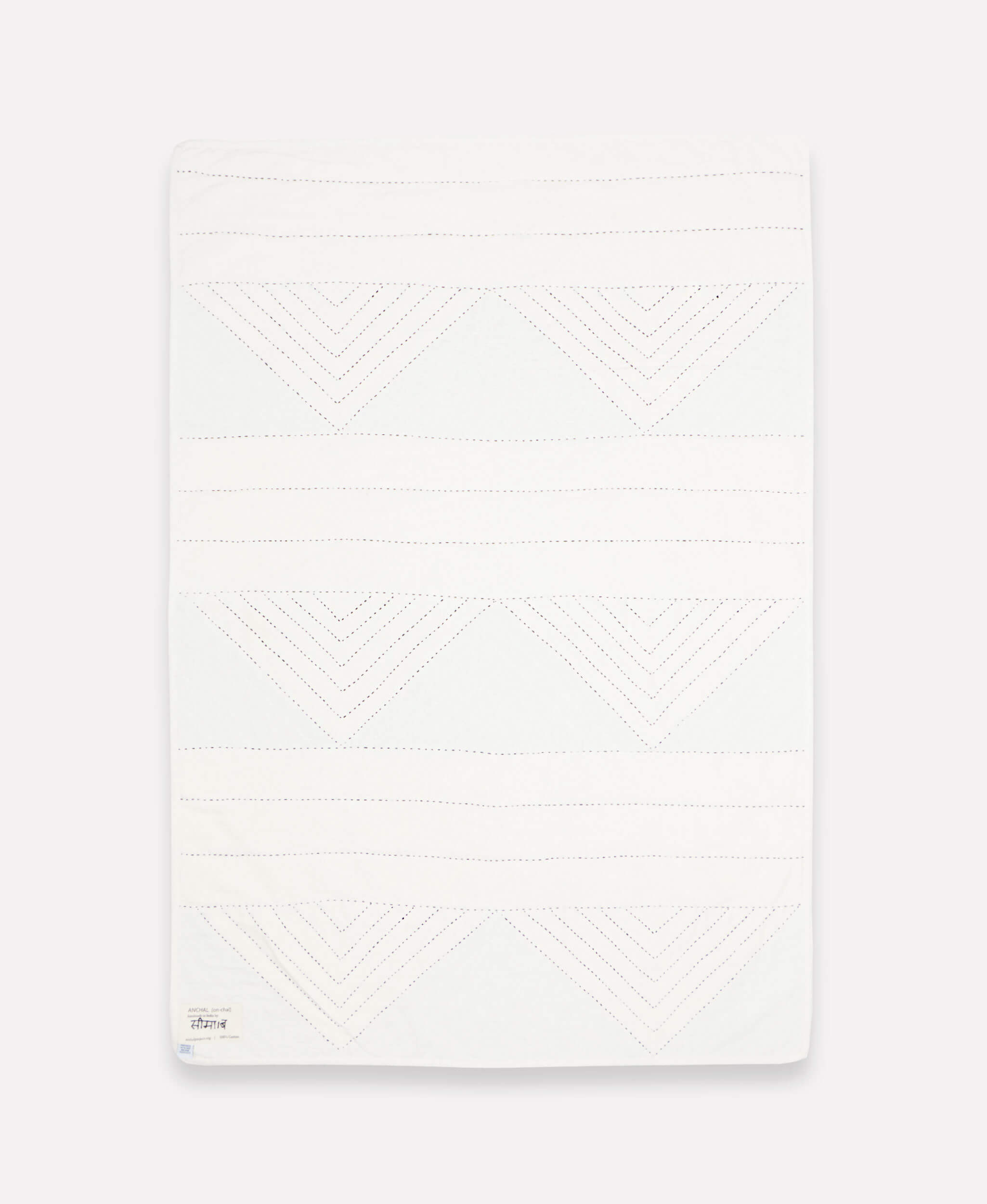 solid white back of slate blue triangle patchwork quilt throw