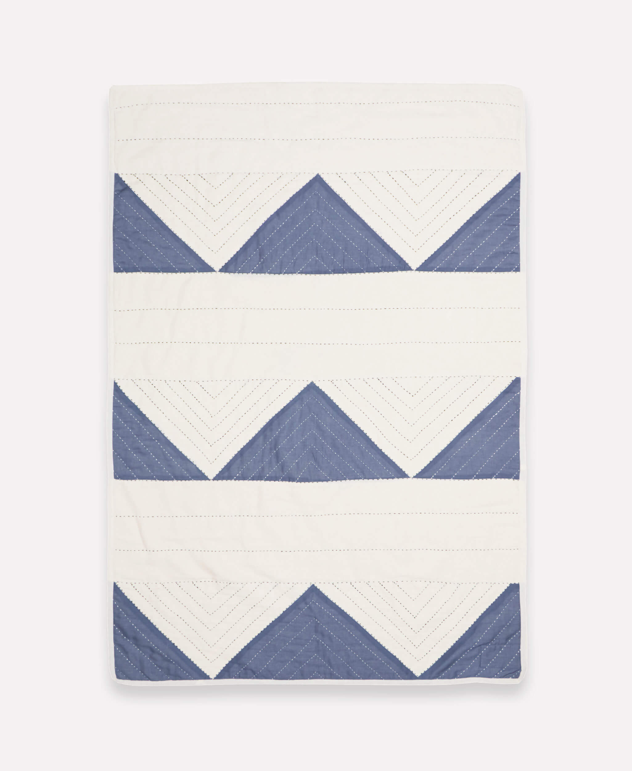 Quilt with blue and white chevron pattern on a white background handmade in India