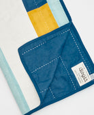 Blue fabric with yellow and light blue sections on a white background