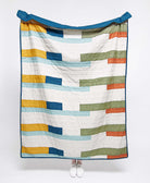 Colorful striped quilt on a white background