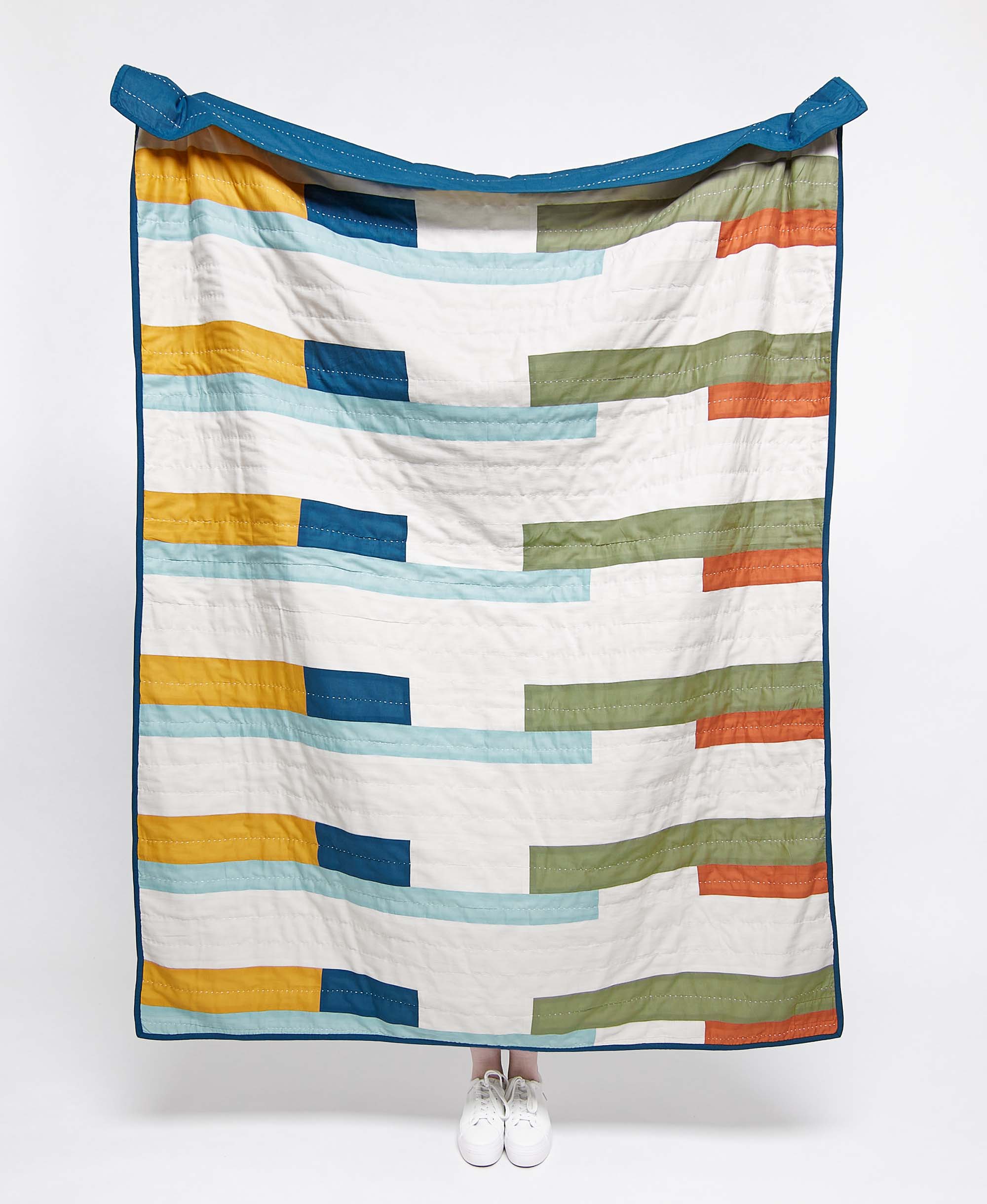 Colorful striped quilt on a white background