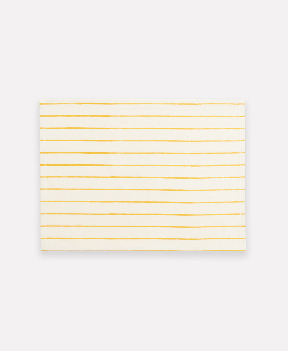 White cotton placemat with thin yellow stripes on a white background